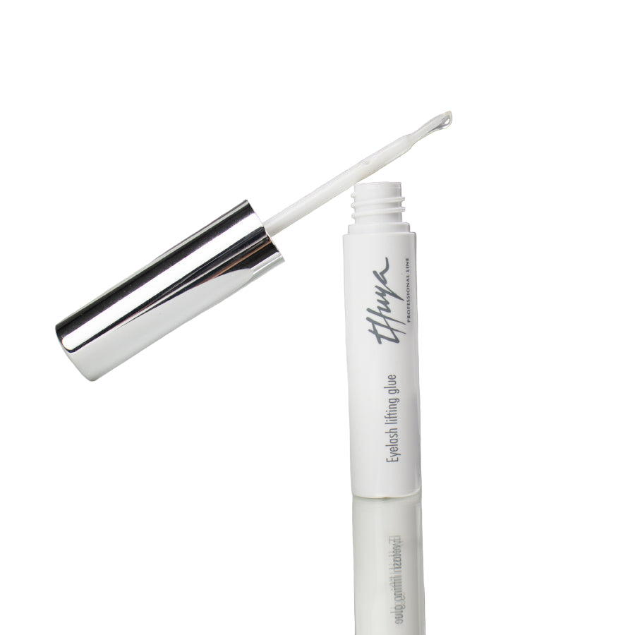 Thuya Eyelash Lifting Glue, clear adhesive for securing lashes during lifts, ensuring strong hold and long-lasting results. small white tube with silver lid, Brush attached to the lid