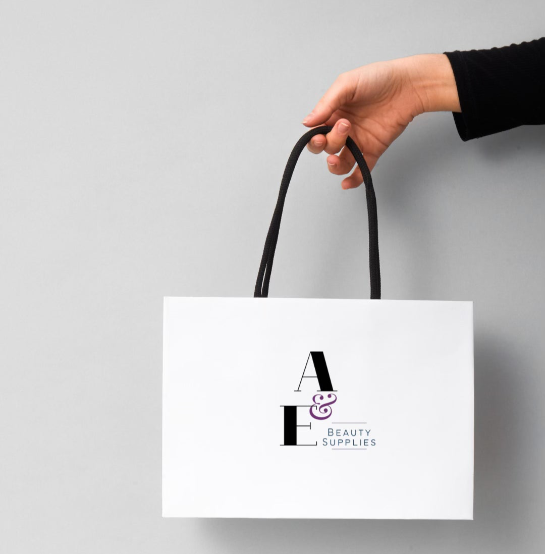 Arm holding out a white A & E shopping bag