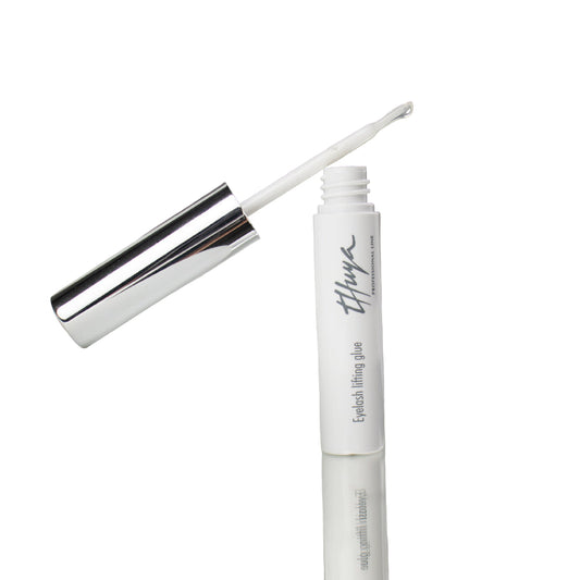 Thuya Eyelash Lifting Glue, clear adhesive for securing lashes during lifts, ensuring strong hold and long-lasting results. small white tube with silver lid, Brush attached to the lid 
