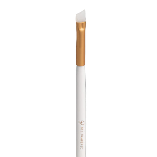 A sleek silicone brush with a flexible, soft tip for precise application of beauty products, brow, lash, and skincare treatments, displayed on a clean, neutral background.